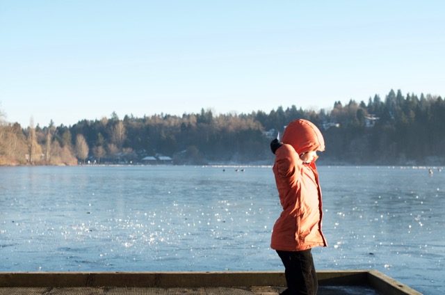 Throwing ice bits onto the frozen lake